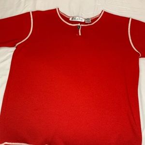Red with white stitching tee shirt.